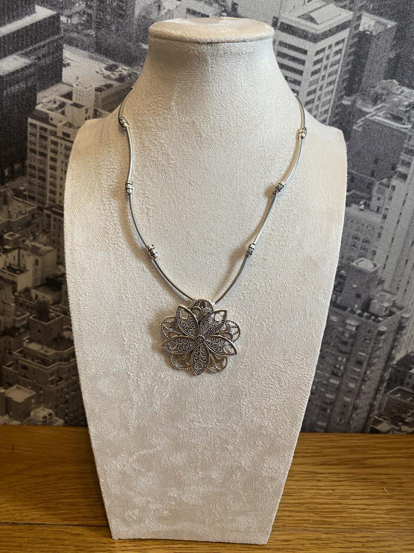 Quirky Floral Design Pendant In A Silver Colour With Solid Linear Link Chain