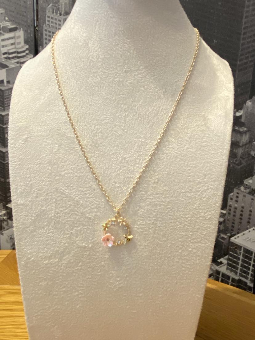 Golden Coloured Hollow Pendant Embellished With Flowers And A Bee