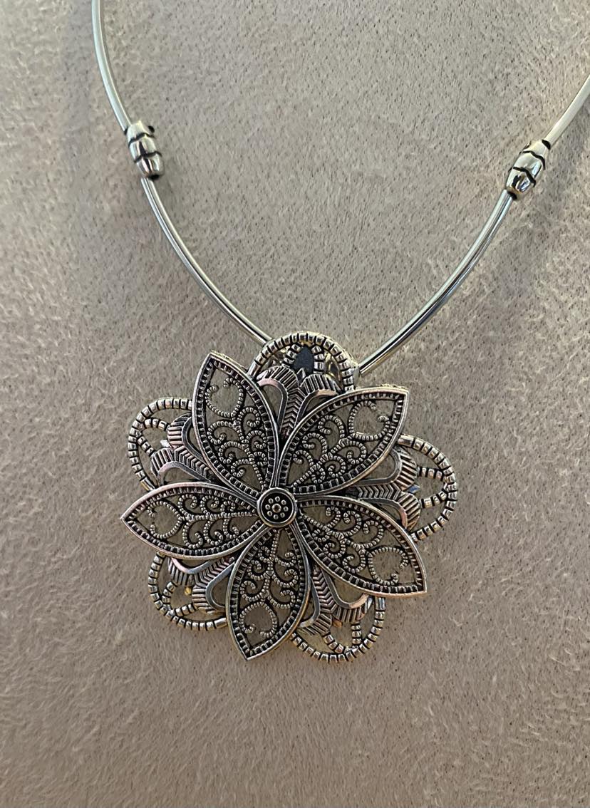 Quirky Floral Design Pendant In A Silver Colour With Solid Linear Link Chain