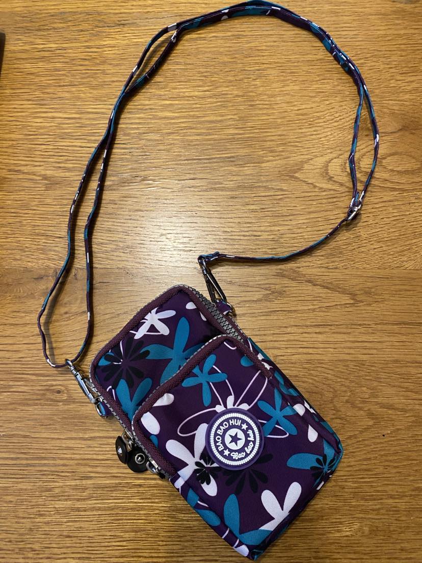 Purple crossbody phone bag with white and green flowers