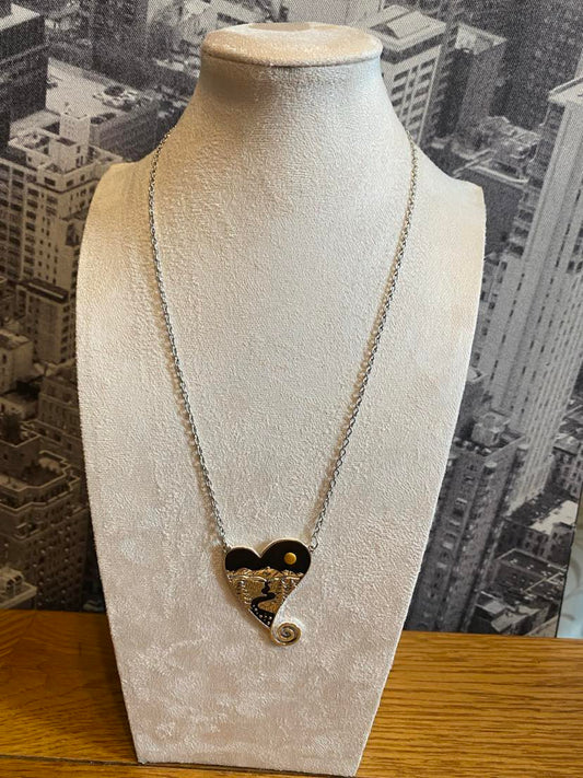 Bohemian Heart Design Pendant Featuring A Rising Sun And A River Scene With Silver Coloured Chain