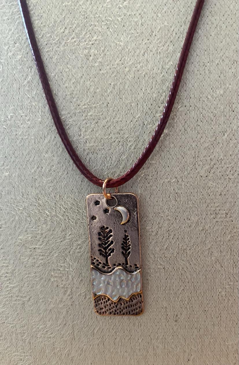 Unusual Long Copper Effect Scene Pendant With A Maroon Coloured Cord