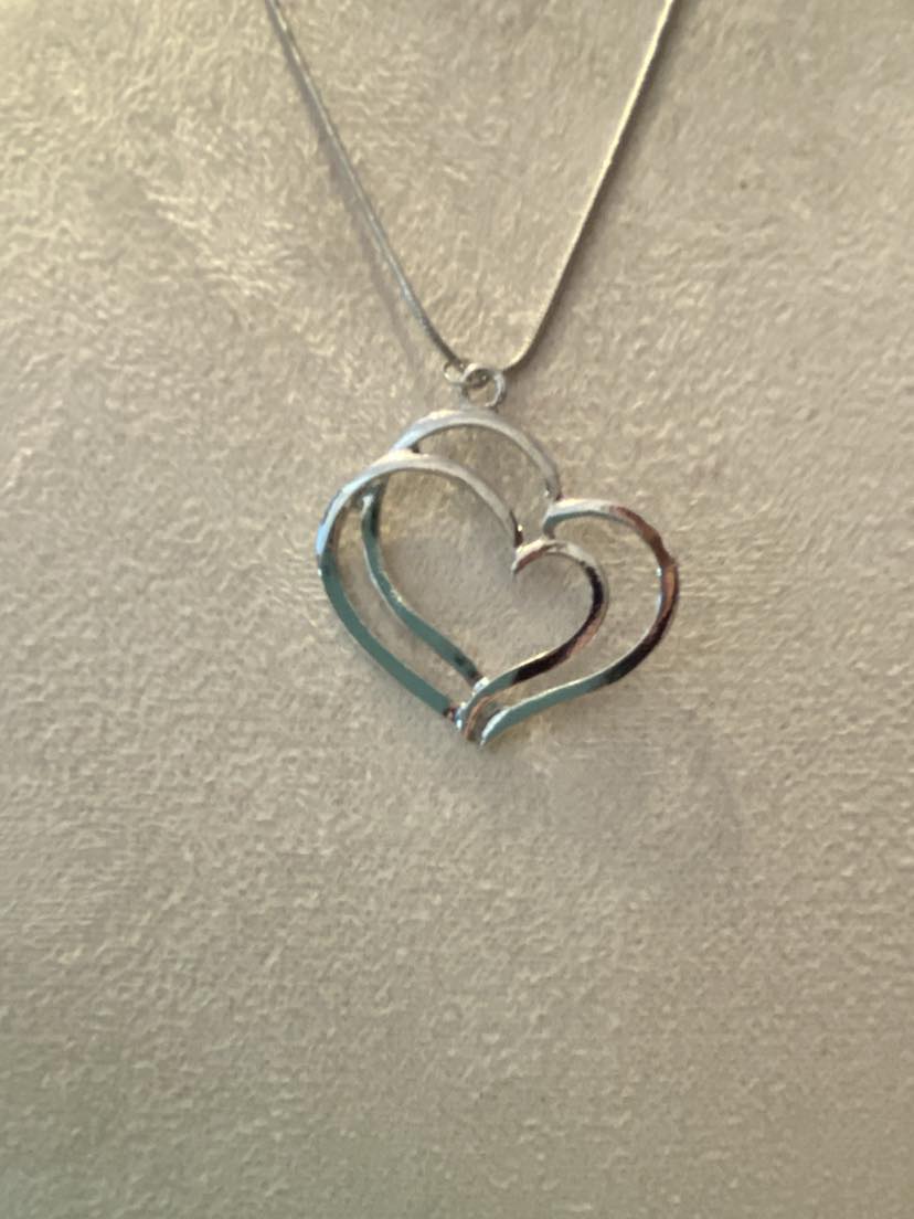 Simply Beautiful Double Heart Pendant on a silver coloured chain
