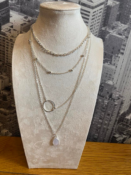 Delicate Silver Coloured Multi Layer Necklace With A Solid Ring, A White Stone And Patterned Chains
